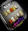 Set of decorative nail art designs in a clear display case with 'Angel' branding.