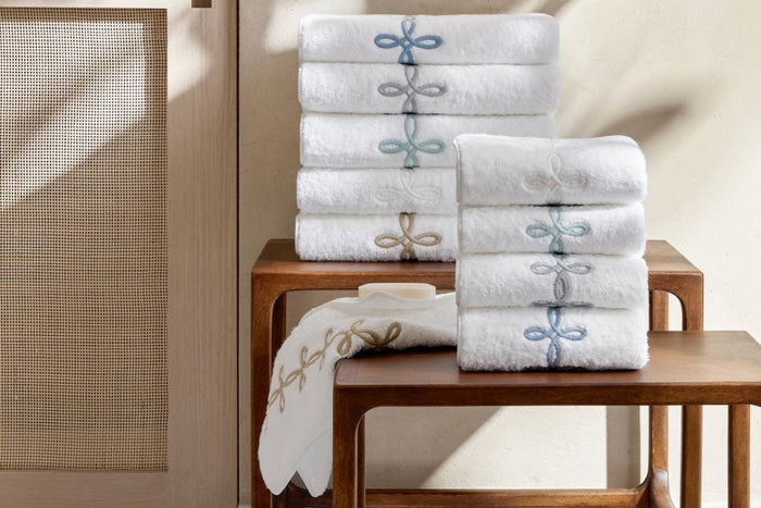 Gordian Knot Bath Towels by Matouk at Fig Linens and Home - Stack of all colors