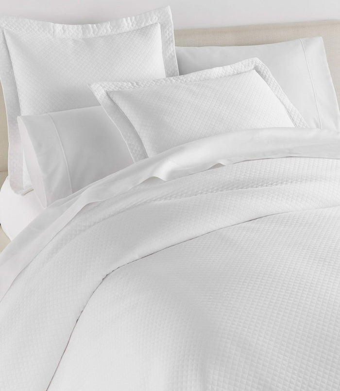 Peacock Alley Oxford White Matelasse Coverlet and Shams on Bed at Fig Linens and Home