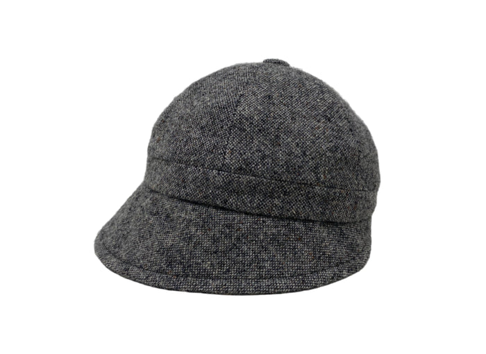 The Hanna Hats Slieve League Hat Tweed is a gray woolen cloche with a short brim and rounded crown, inspired by the Donegal Coast’s dramatic cliffs. Shown on a white background.