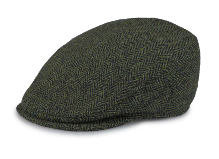 The Vintage Cap Tweed by Hanna Hats is a dark green herringbone flat cap with a textured fabric, short curved brim, and fitted rounded crown.